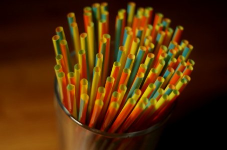Colorful Plastic Straw On A Glass Container photo