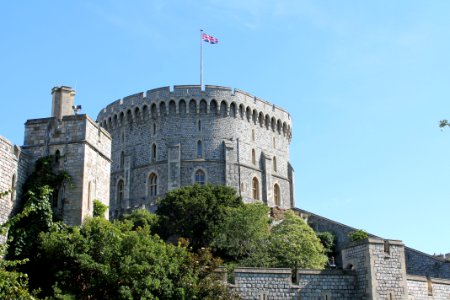 Gray Concrete Castle With Flag On Top Under Blue Sky