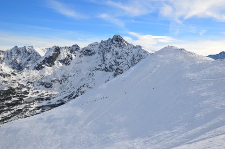 Alpine Hikers On Snowy Mountain photo