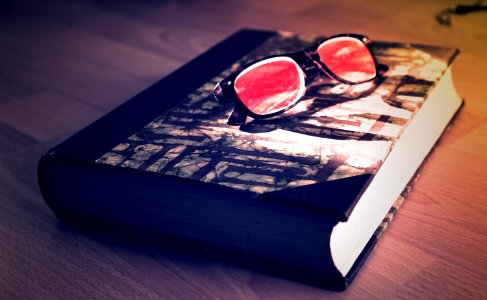 Black Framed Sunglasses On Black Book photo