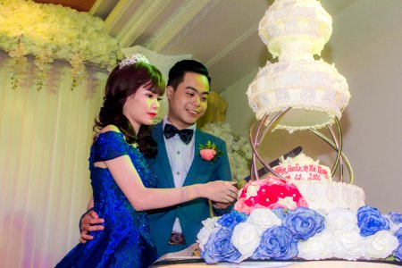Wedding Couple Cutting Wedding Cake photo