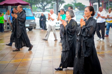 Asian Adults In Somber Parade