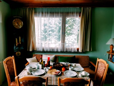 Arranged Table With Chairs And Plates Near Window photo