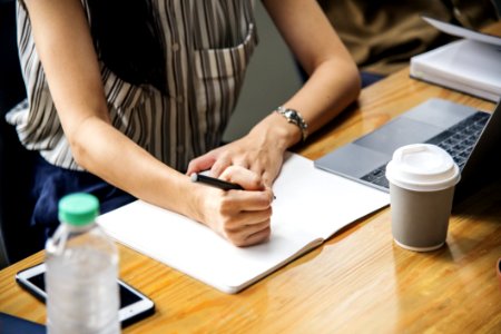 Woman Holding Pen With White Printer Paper photo