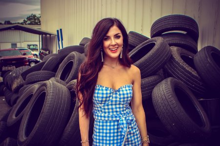 Woman Standing Behind Tires photo
