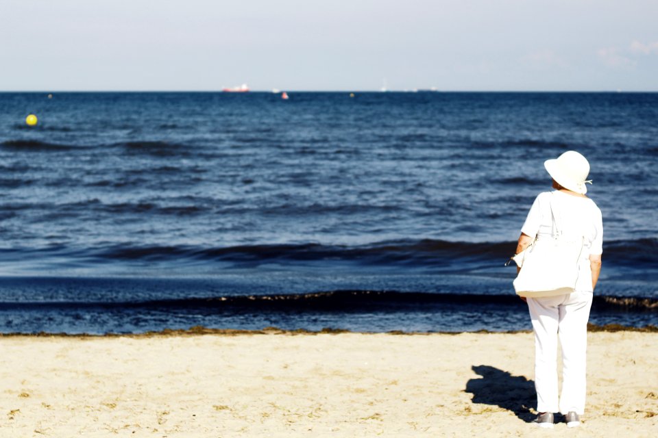 Photo Of Woman Standing On Seashore photo