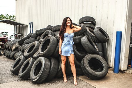 Woman Posing In Front Of Tires photo