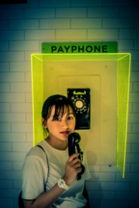 Woman In White Shirt Holding Telephone photo