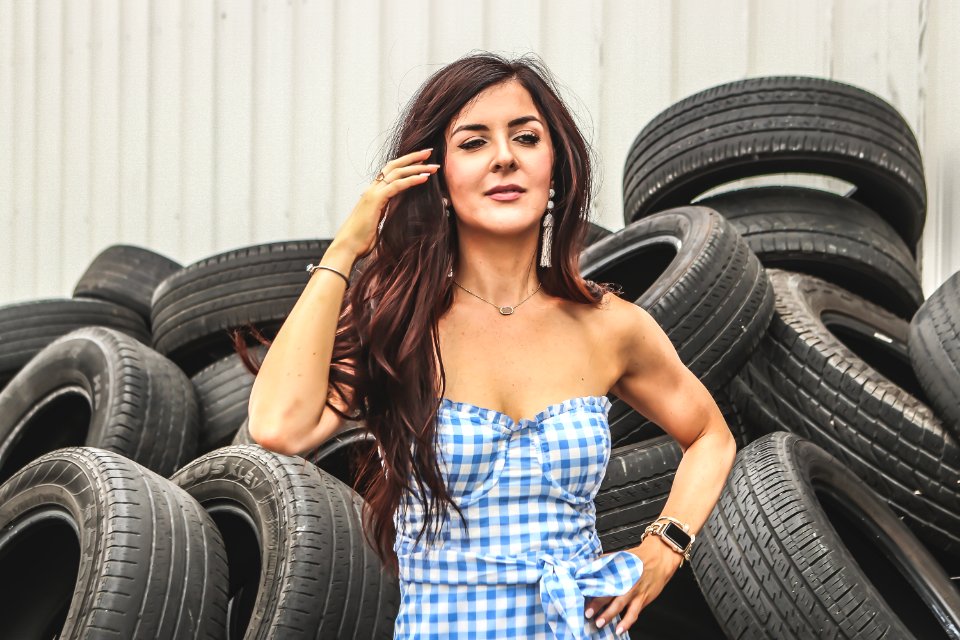 Woman Standing In Front Of Car Tires