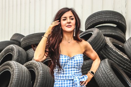 Woman Standing In Front Of Car Tires