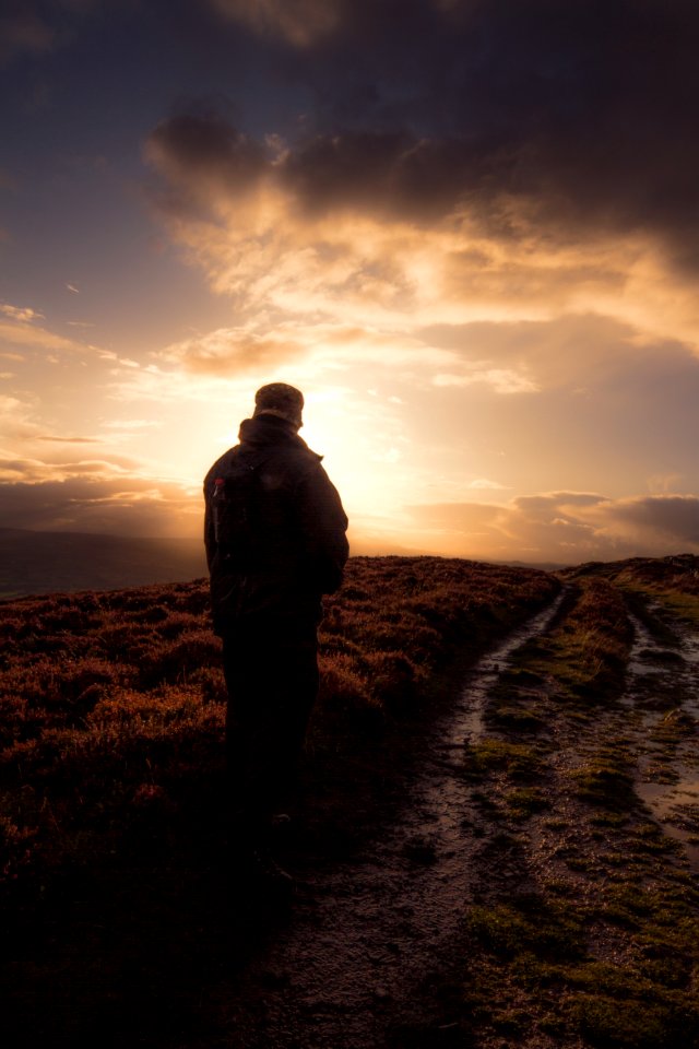 Man Standing In Muddy Field Path