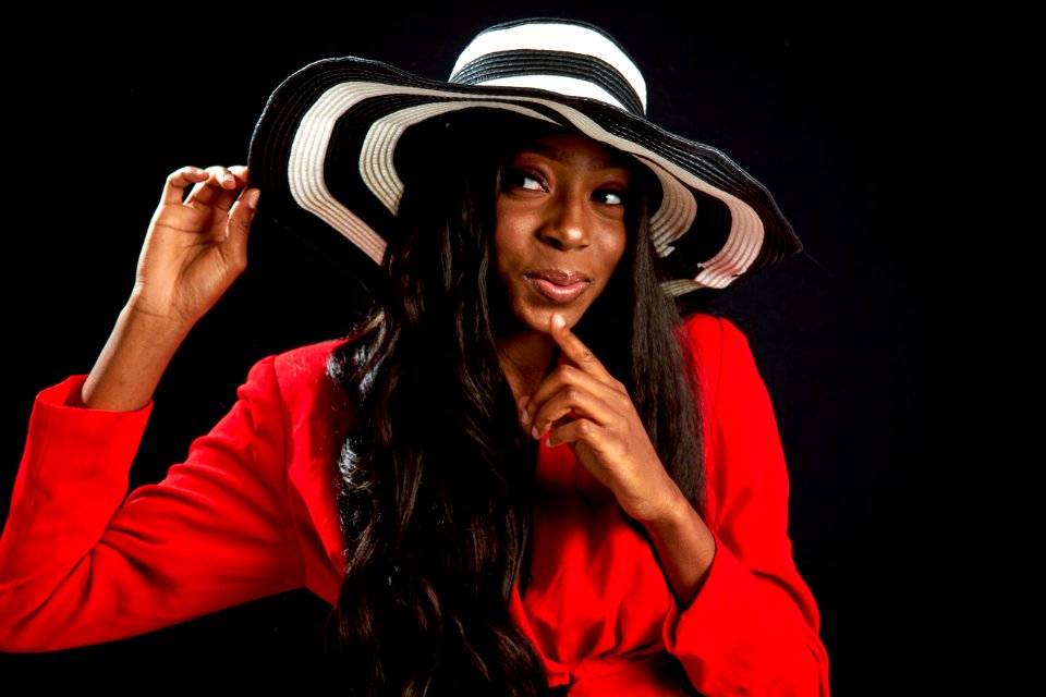 Woman Holding White And Black Hat