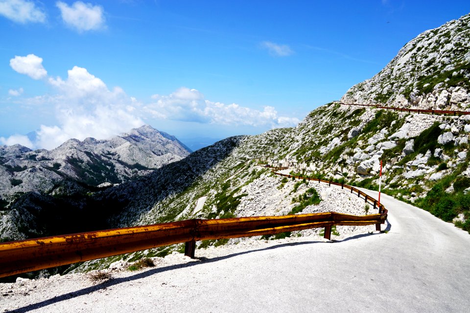 Photo Of Narrow Paved Mountain Road With Barrier