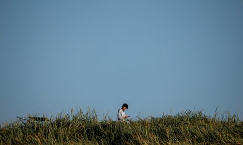 Man Standing On Green Grass