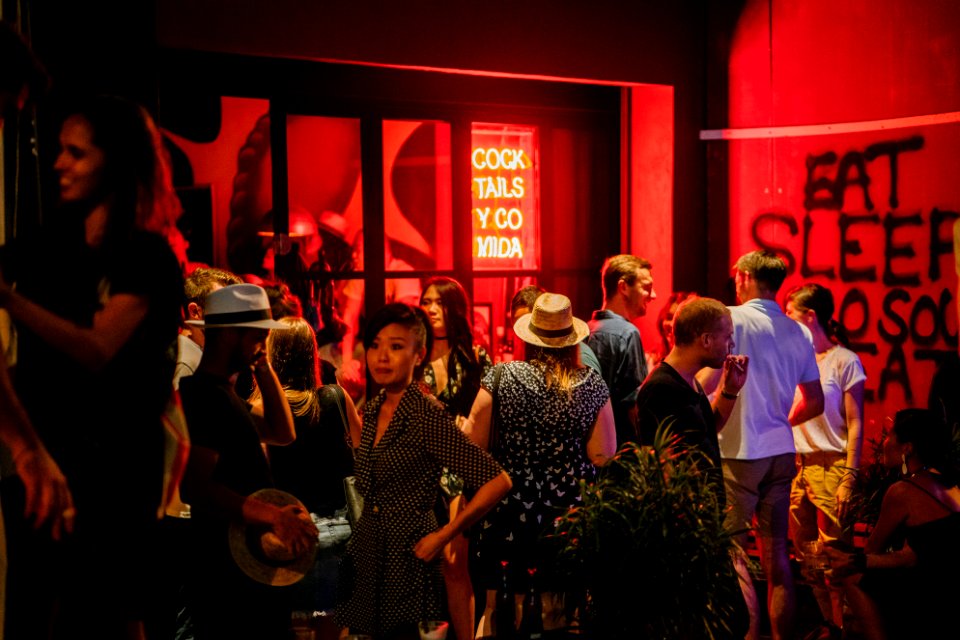Group Of People Standing Waiting Outside The Bar