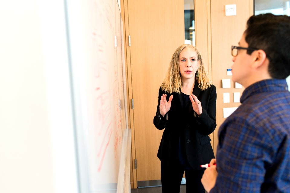 Woman Standing Near Whiteboard