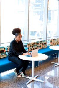 Woman In Black Outfit Working On A Laptop