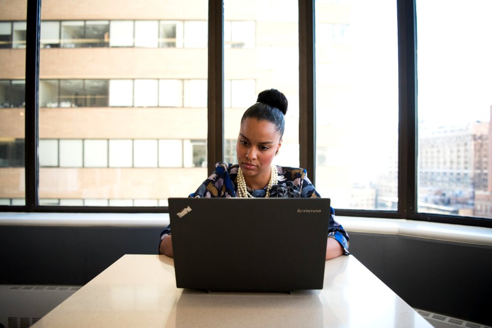 Woman Sitting On Sofa Facing Lenovo Thinkpad