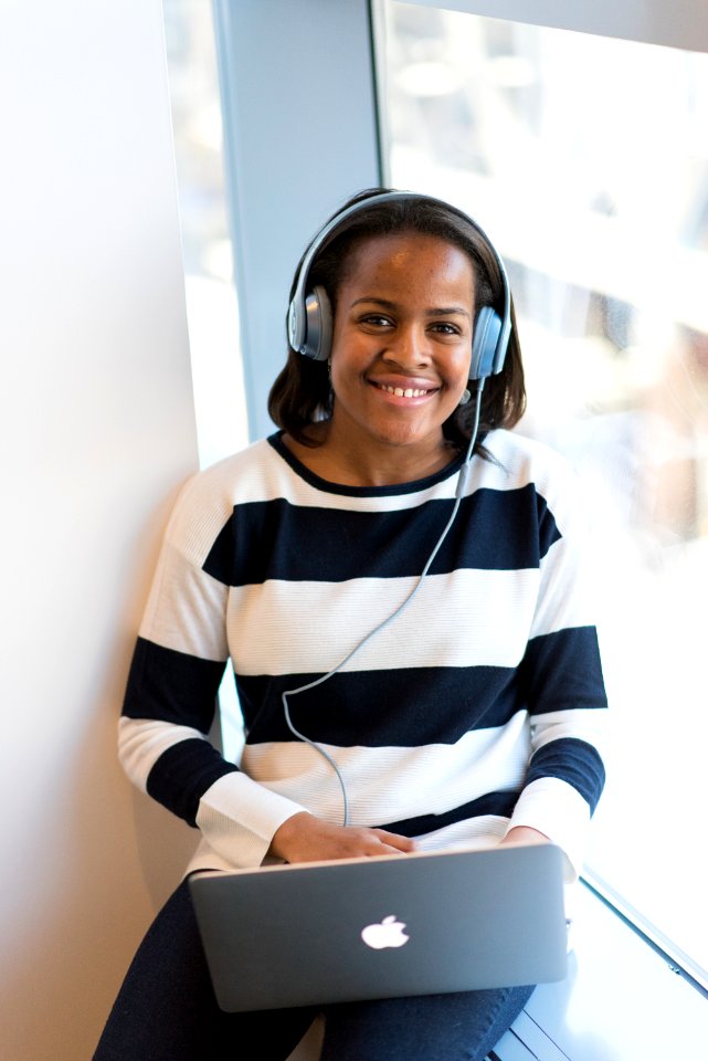 Woman Wearing White And Black Stripe Long-sleeved Shirt Holding Macbook
