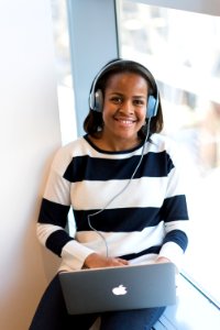 Woman Wearing White And Black Stripe Long-sleeved Shirt Holding Macbook