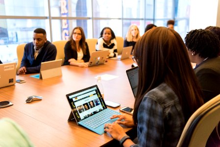 Group Of People Sitting Near Table photo