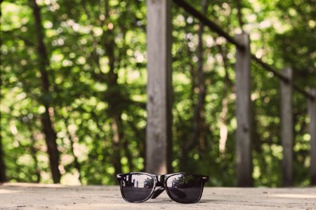 Black Framed Wayfarer-style Sunglasses On Floor