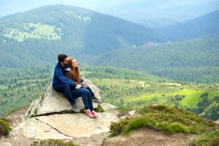 Photo Of Couple Sitting On Rock photo