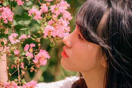 Close-Up Photography Of Girl Near Pink Flower photo