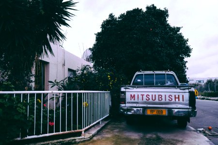 Gray Mitsubishi Car Parking Near White Hand Rails