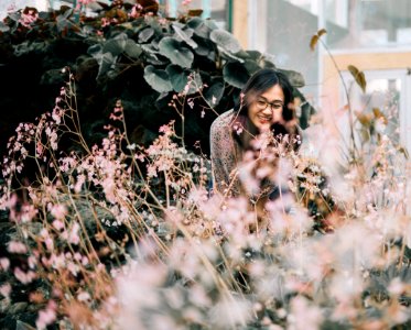 Woman Wearing Black Framed Eyeglasses Standing Near Flowers