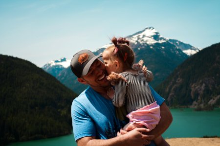 Man Carrying Her Daughter Smiling photo