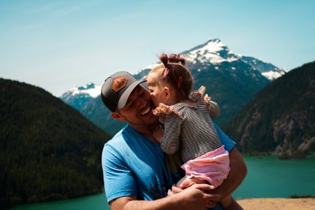 Man Carrying Her Daughter Smiling