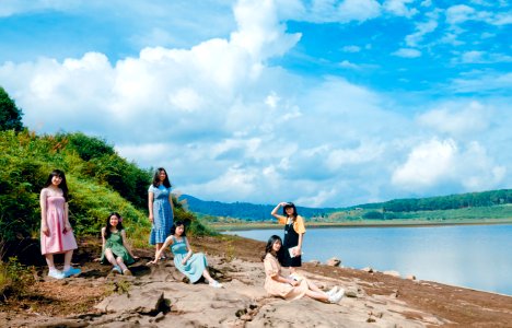 Women Sitting Near Body Of Water photo