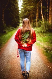 Woman Holding Leaves On Her Back photo
