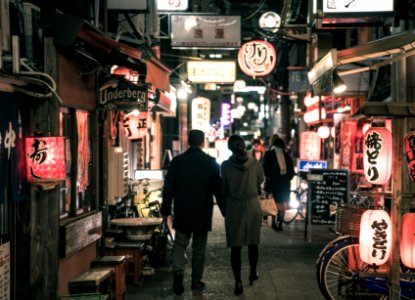 Couple Walking On Street At Night photo