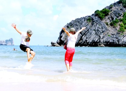 Woman And Man Playing On Seashore photo