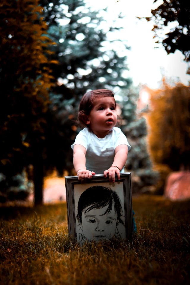 Girl Wearing White Shirt Holding Photo Frame