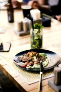 Round Black Plate With Silver Steel Bread Knife photo