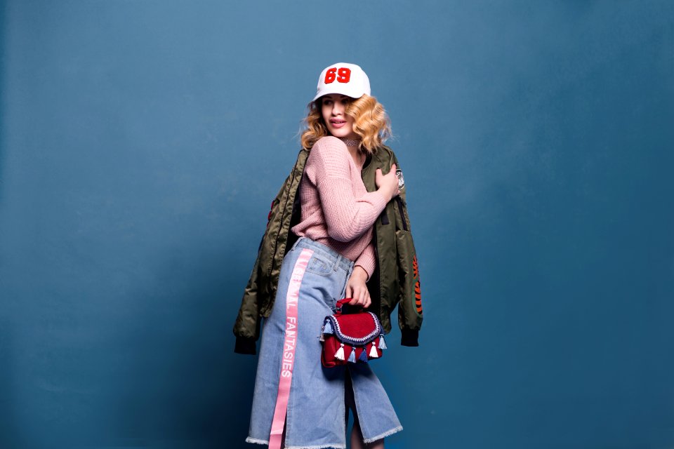 Woman In Pink Sweater And Denim Skirt