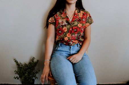 Woman Sitting On Chair Beside Green Plant