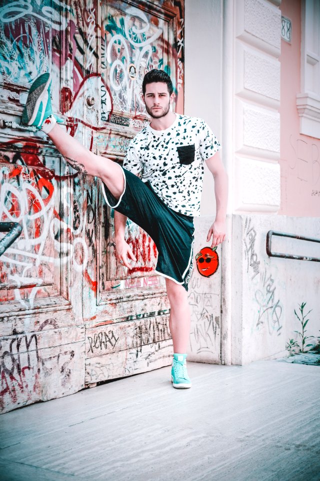 Man Wearing Black And White Crew-neck T-shirt With Right Foot Up photo