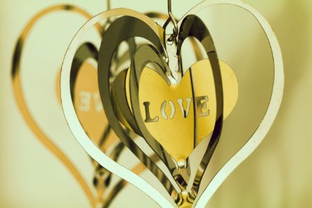 Shallow Focus Photography Of Silver And Gold Heart Pendants