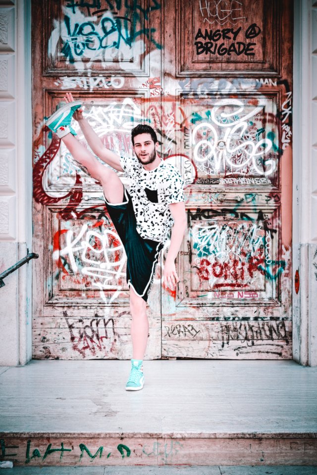 Man Wearing Black And White Crew-neck T-shirt With Foot Up photo