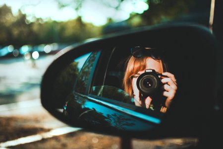 Selective Focus Photography Of Woman Taking Camera Through Mirror photo