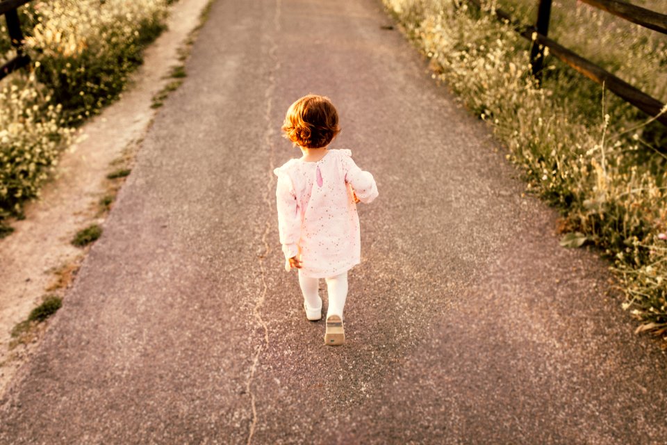 Girl Wearing White Clothes Walking On Pavement Road photo