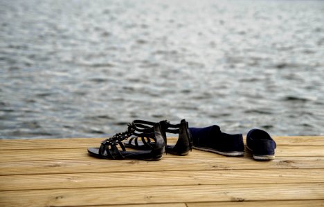 Two Pairs Of Sandals On Wood Floor photo