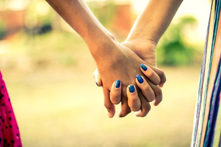 Shallow Focus Photography Of Two Person Holding Hands photo