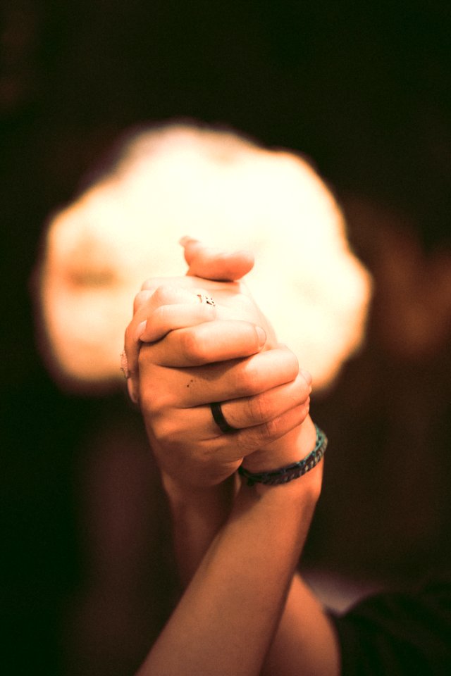 Shallow Focus Photography Of Two Persons Holding Hands