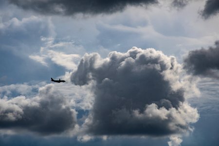 Airplane Flying Near Gray Clouds photo