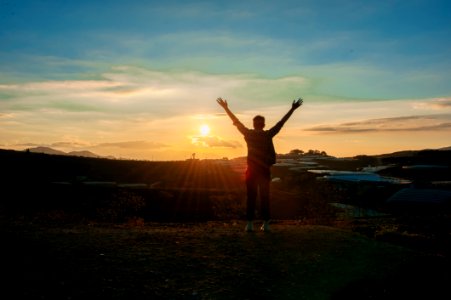 Photography Of Man Raising Both Hands photo